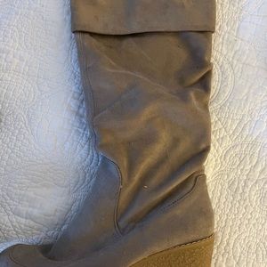 Knee high suede boots with side zipper. Cozy and comfortable with a wedged heel.